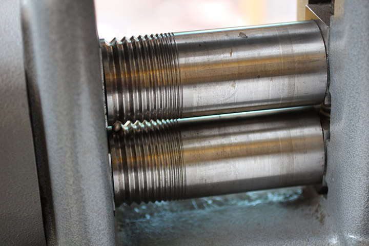 This mill is used to roll out an ingot of gold into a wire, which can then be fashioned into a circular ring shape.