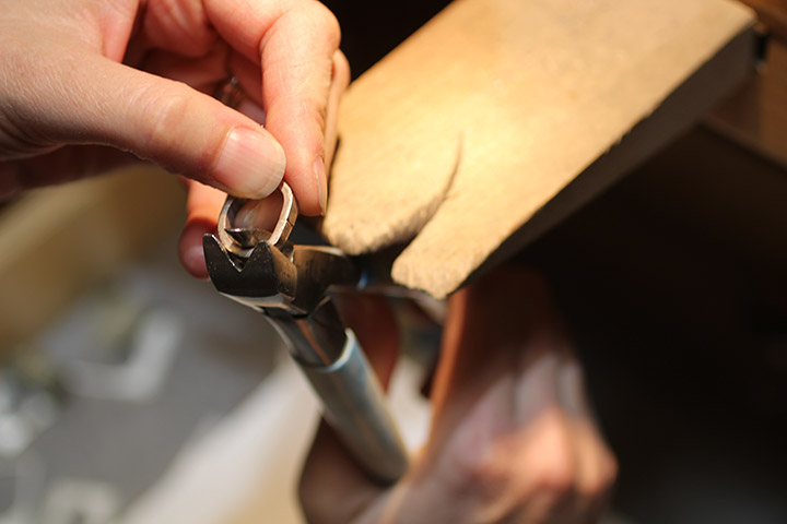 Once the gold from the old wedding ring is rolled out, our artisans use hand tools to form it into the shape of the new wedding ring.