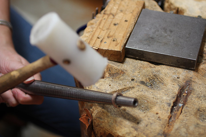 Hammering the old gold into a new wedding ring is a key part of the process—it helps define the size and shape of the new ring from old gold.