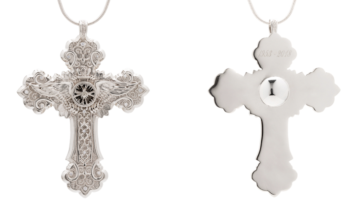 An intricate custom cross pendant necklace designed to hold a loved one's cremated remains/ashes.