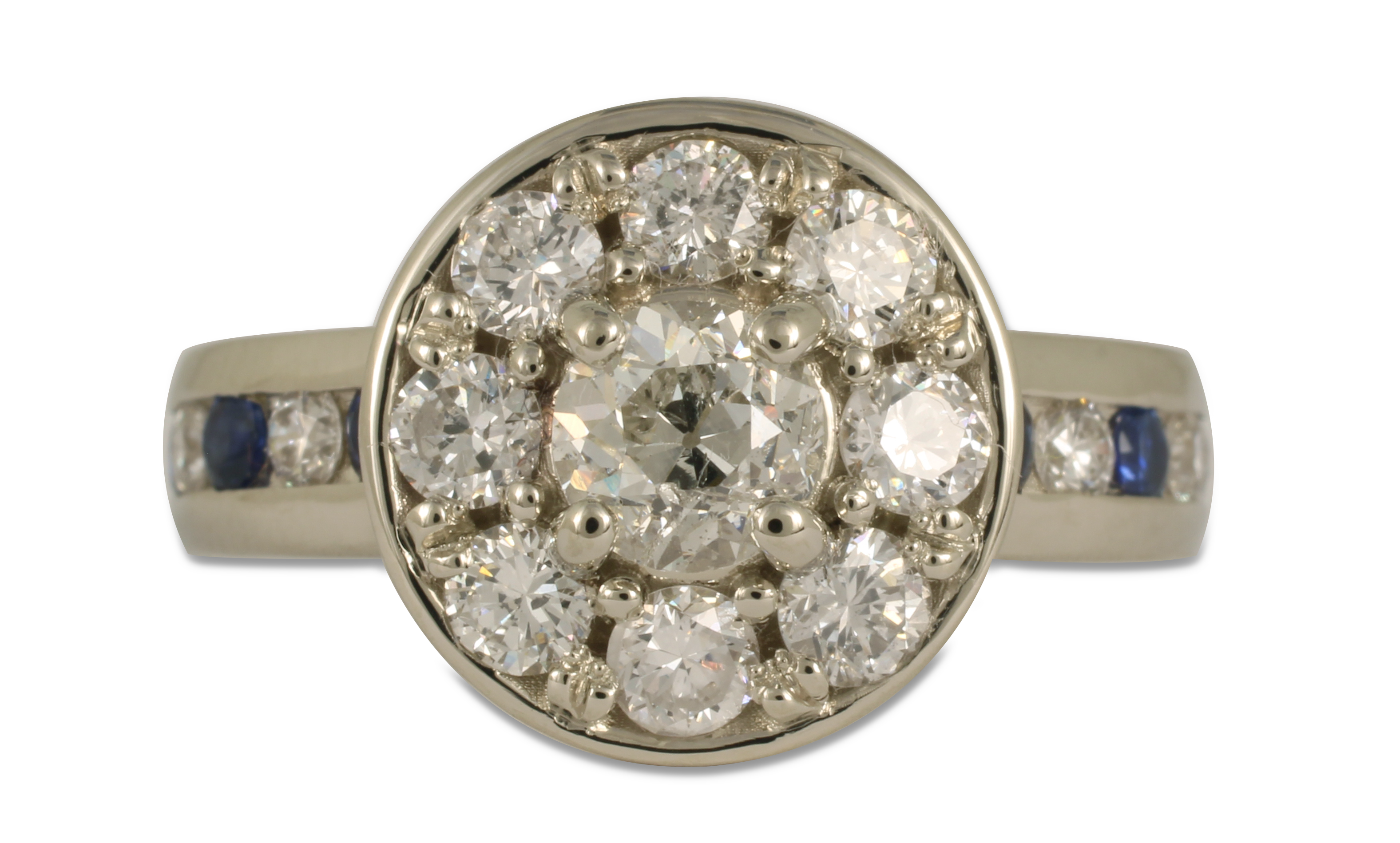 This reset diamond project took an outdated, multi-diamond ring, and and turned it into this gorgeous, modern, halo diamond and sapphire ring.