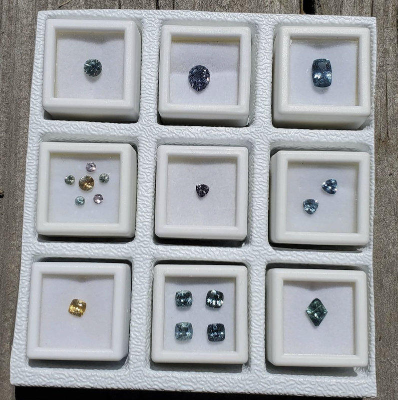 A range of montana sapphires — portuguese cut, cushion cut, trilliant and pear shaped in purple, orange, blue, and green